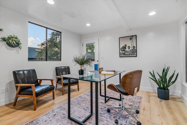 office space with light hardwood / wood-style floors and beamed ceiling