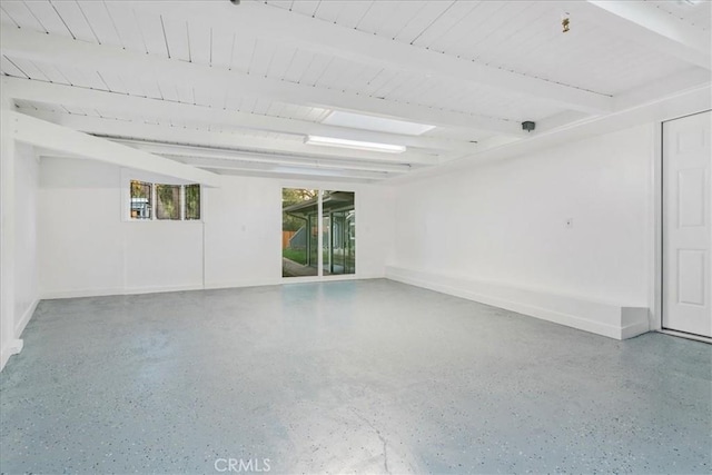 empty room featuring beam ceiling