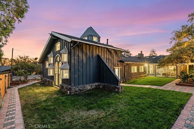 back house at dusk with a yard