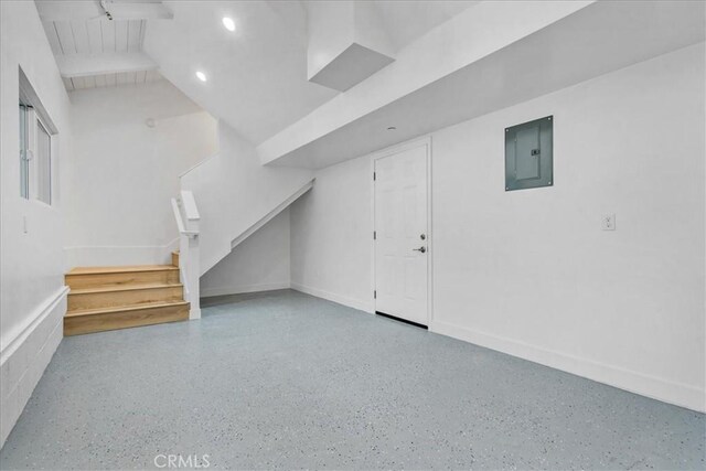 bonus room featuring beam ceiling and electric panel