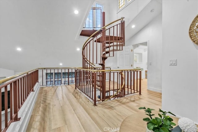 staircase featuring vaulted ceiling and hardwood / wood-style flooring