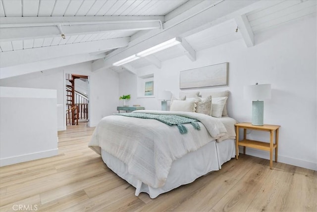 bedroom with wood-type flooring and lofted ceiling with beams