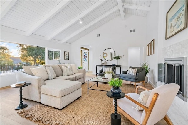 living room with high vaulted ceiling, beam ceiling, plenty of natural light, and hardwood / wood-style flooring