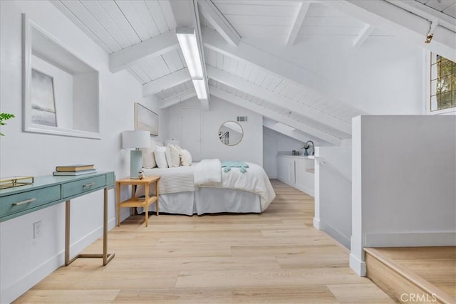 bedroom with vaulted ceiling with beams and light wood-type flooring