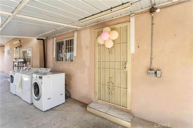 clothes washing area with separate washer and dryer