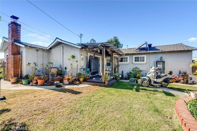 rear view of house featuring a lawn