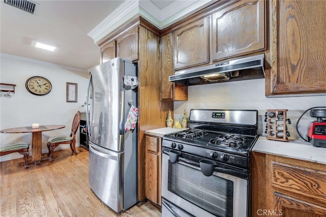 kitchen with appliances with stainless steel finishes, crown molding, and light hardwood / wood-style floors