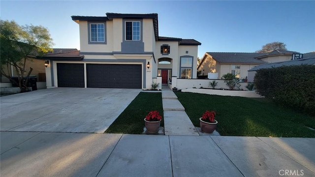 view of front of property featuring a garage and a front lawn