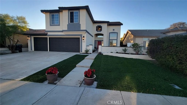 view of front of house with a garage and a front lawn