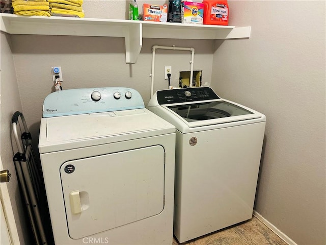 clothes washing area with light wood-type flooring and washing machine and clothes dryer