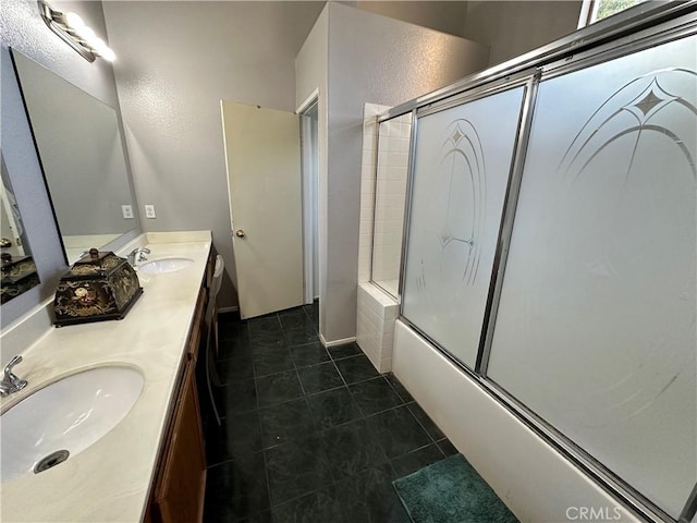 bathroom with tile patterned flooring, vanity, and combined bath / shower with glass door