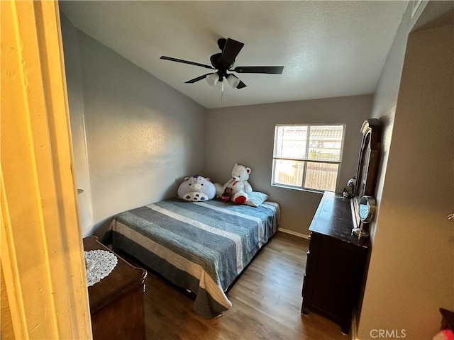 bedroom featuring ceiling fan and dark hardwood / wood-style floors