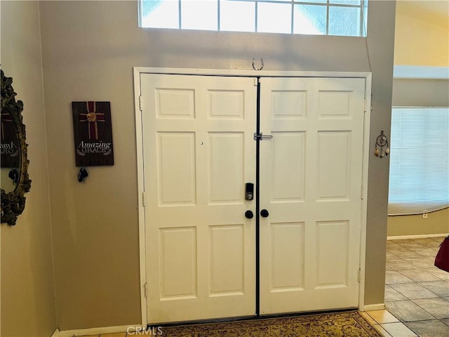 tiled foyer entrance with a healthy amount of sunlight