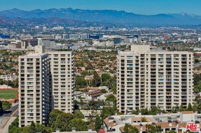 property's view of city featuring a mountain view