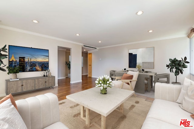 living room featuring crown molding and light hardwood / wood-style flooring