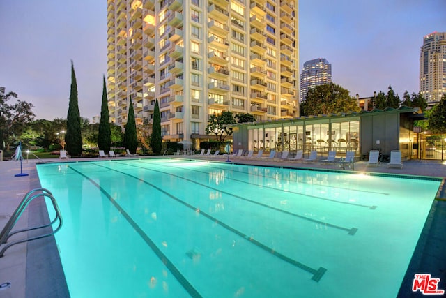 view of pool at dusk