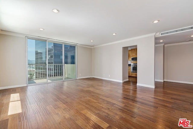 empty room featuring hardwood / wood-style flooring, floor to ceiling windows, and crown molding