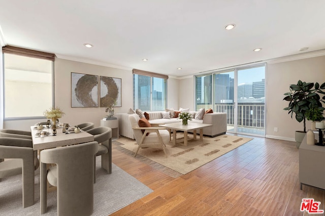 living room with ornamental molding and light wood-type flooring