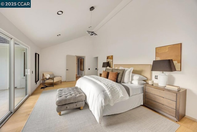 bedroom with light hardwood / wood-style floors and high vaulted ceiling