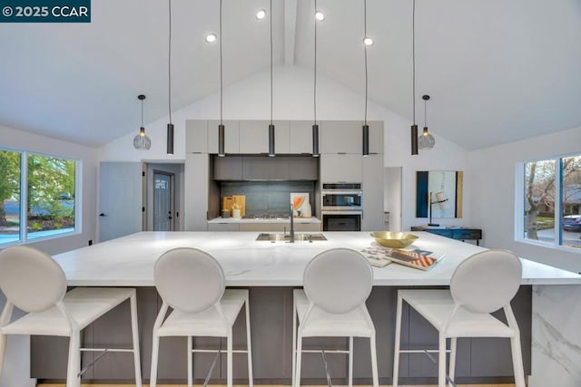 kitchen with backsplash, a breakfast bar area, and pendant lighting