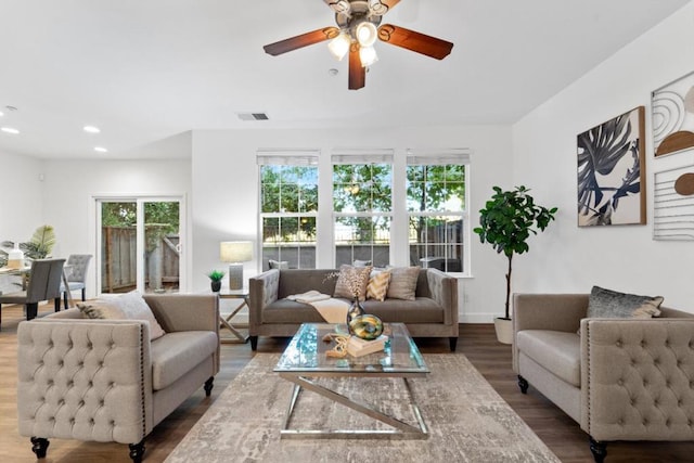 living room featuring ceiling fan, dark hardwood / wood-style floors, and a healthy amount of sunlight