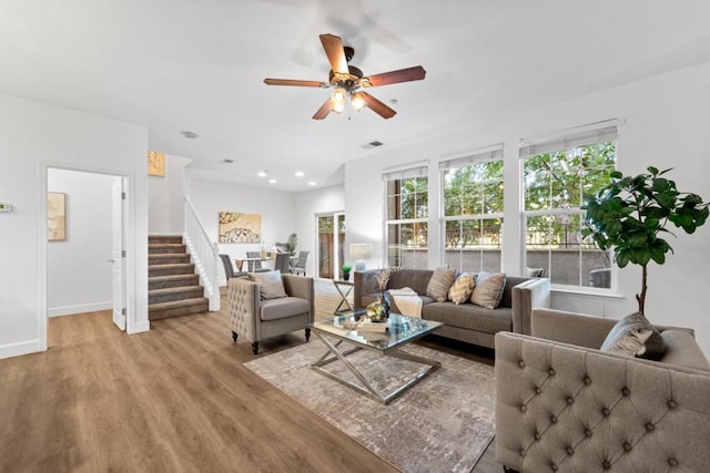 living room featuring ceiling fan and light wood-type flooring