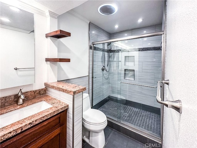 full bathroom with a stall shower, toilet, tile patterned flooring, crown molding, and vanity