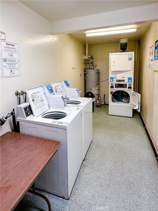 shared laundry area featuring strapped water heater, stacked washer / dryer, and washing machine and clothes dryer