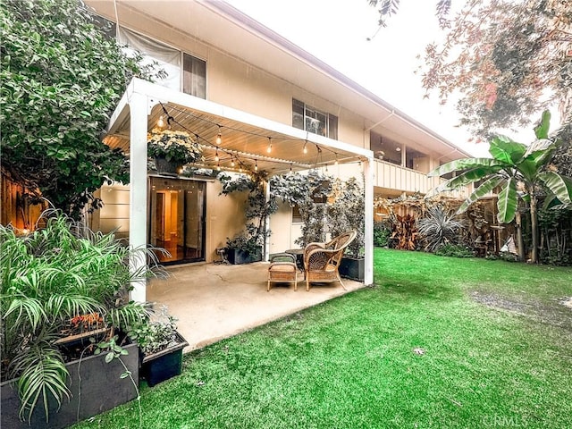 back of house with a patio area, a yard, fence, and stucco siding