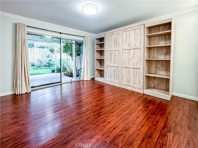 interior space featuring baseboards, dark wood-type flooring, and crown molding