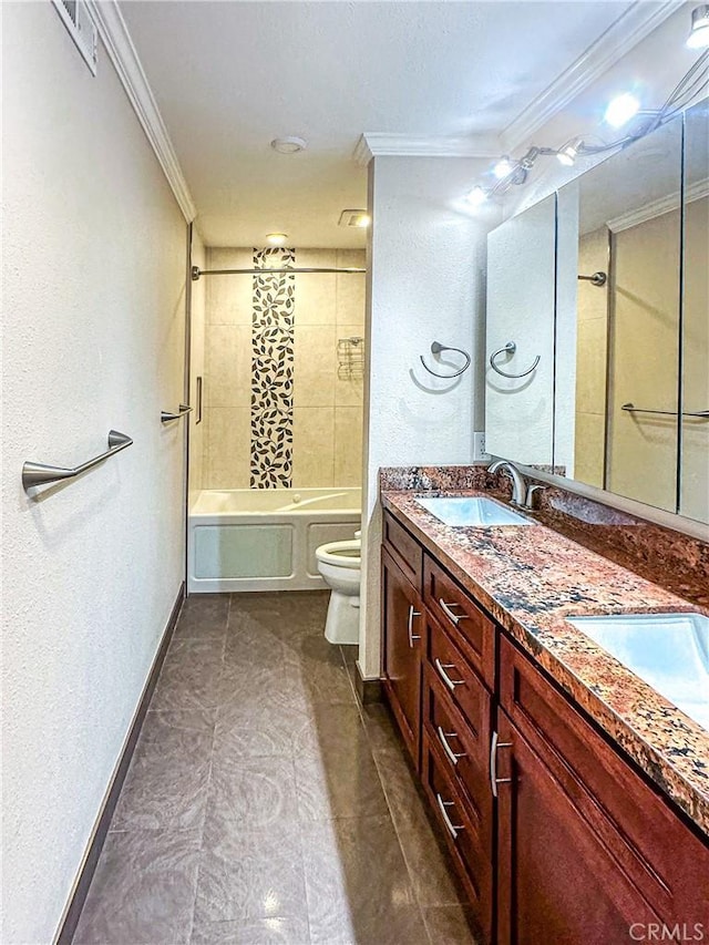 bathroom with crown molding, double vanity, toilet, a sink, and baseboards