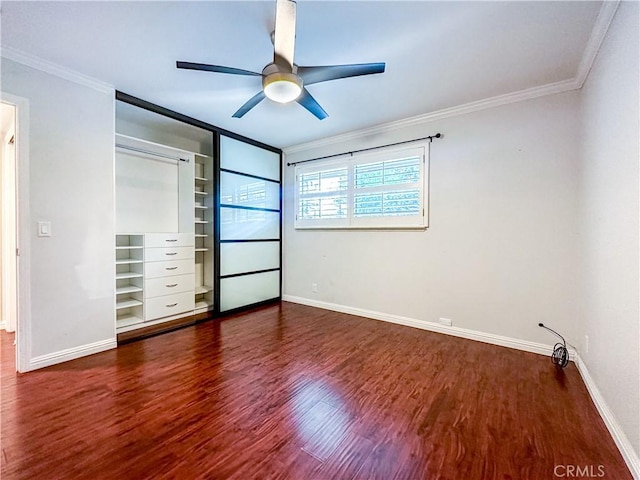 unfurnished bedroom with baseboards, ceiling fan, dark wood-type flooring, and crown molding