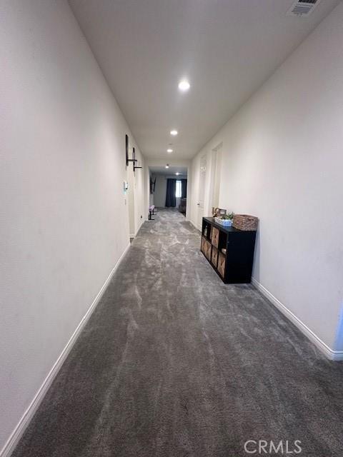 corridor with dark carpet