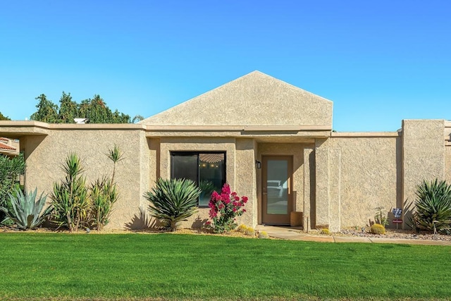 rear view of house featuring a lawn