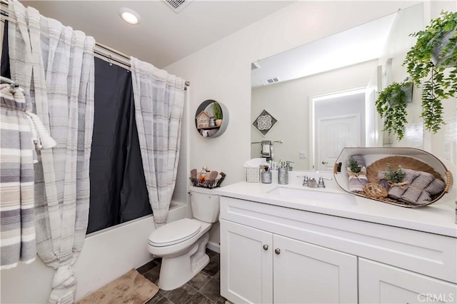 full bathroom with vanity, shower / bath combination with curtain, and toilet