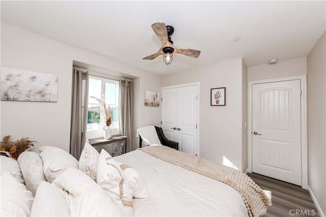 bedroom with hardwood / wood-style floors, a closet, and ceiling fan