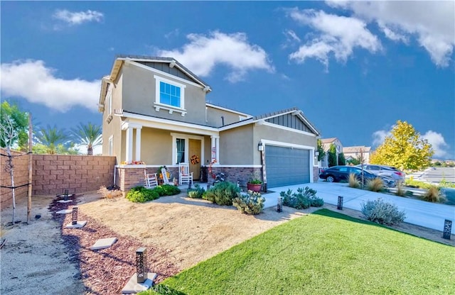 craftsman house with a front yard, a porch, and a garage