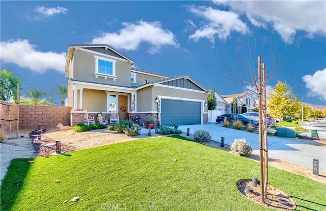 craftsman inspired home featuring covered porch, a garage, and a front yard