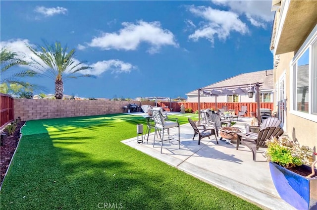 view of yard with a patio and a fire pit