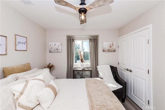 bedroom featuring ceiling fan, a closet, and wood-type flooring