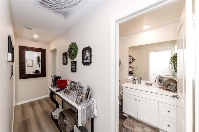 corridor featuring sink and dark hardwood / wood-style floors