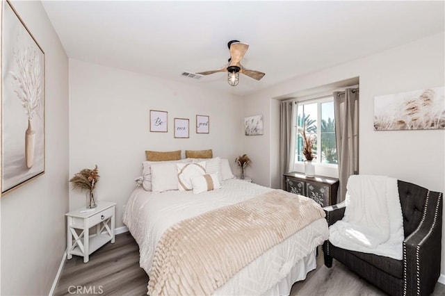 bedroom with ceiling fan and hardwood / wood-style flooring