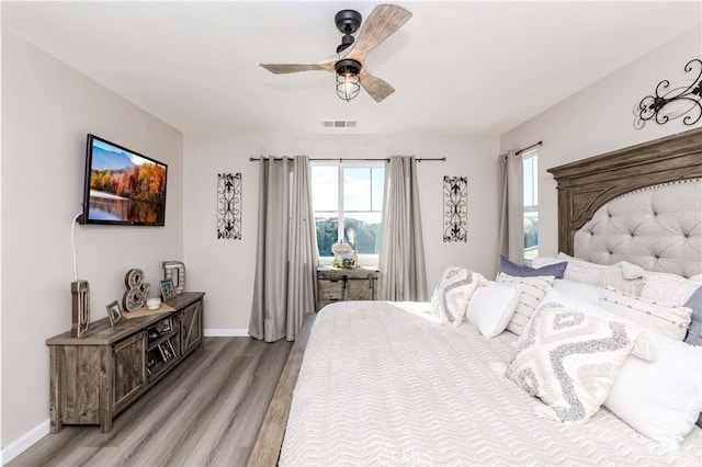 bedroom with ceiling fan and light hardwood / wood-style floors