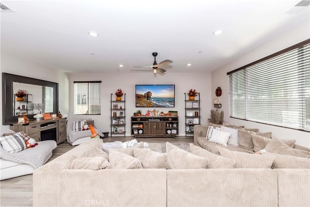 living room with ceiling fan and light wood-type flooring