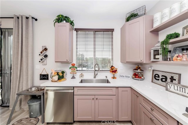 kitchen with dishwasher, light wood-type flooring, and sink