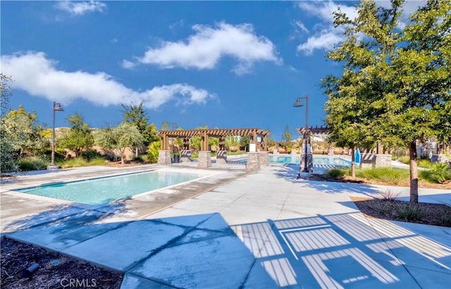 view of pool featuring a pergola and a patio