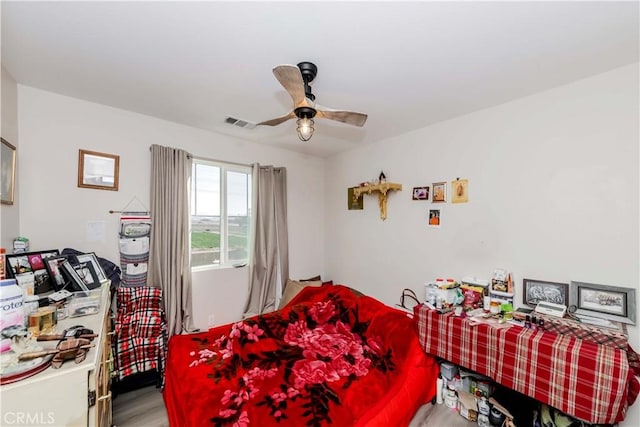 bedroom with ceiling fan and light hardwood / wood-style flooring