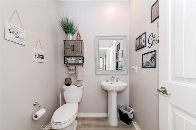 bathroom featuring hardwood / wood-style floors and toilet