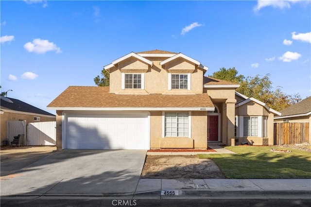 view of property featuring a front lawn and a garage