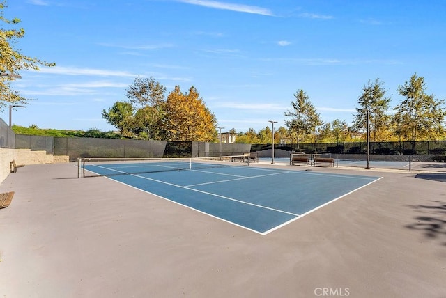 view of tennis court with basketball hoop